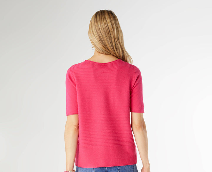 Person wearing a pink top and blue jeans on a white background
