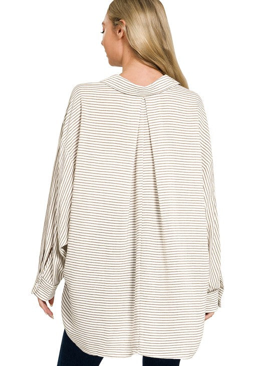 Woman wearing a beige and white striped long-sleeve top on a white background