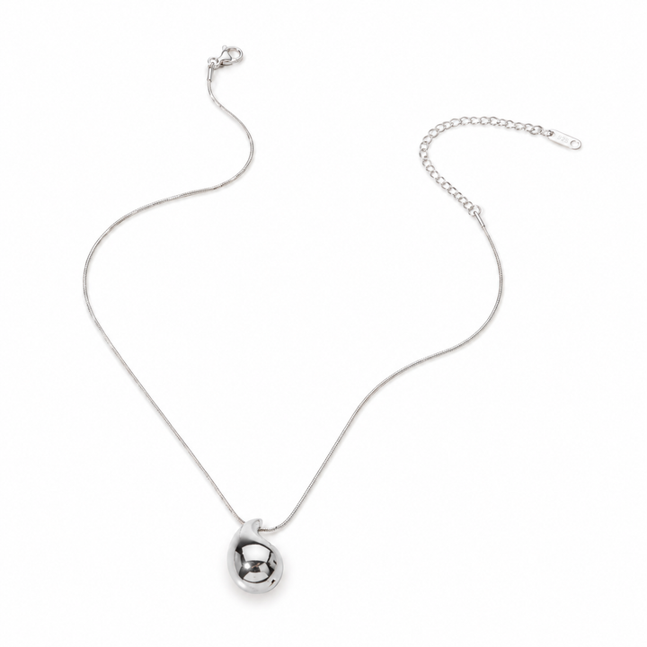 Silver necklace with a small round pendant on a white background