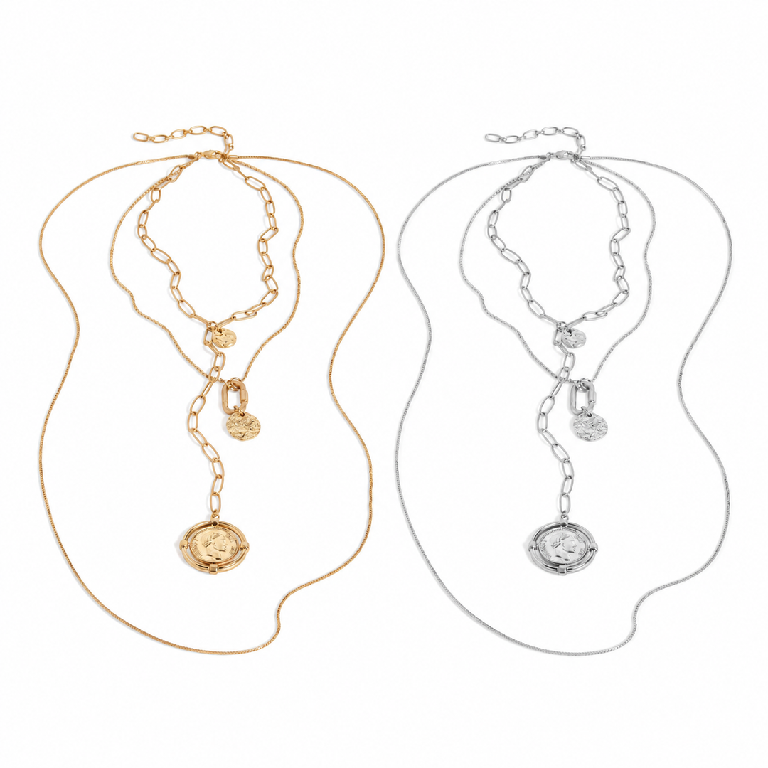 Two necklaces, one gold and one silver, on a white background