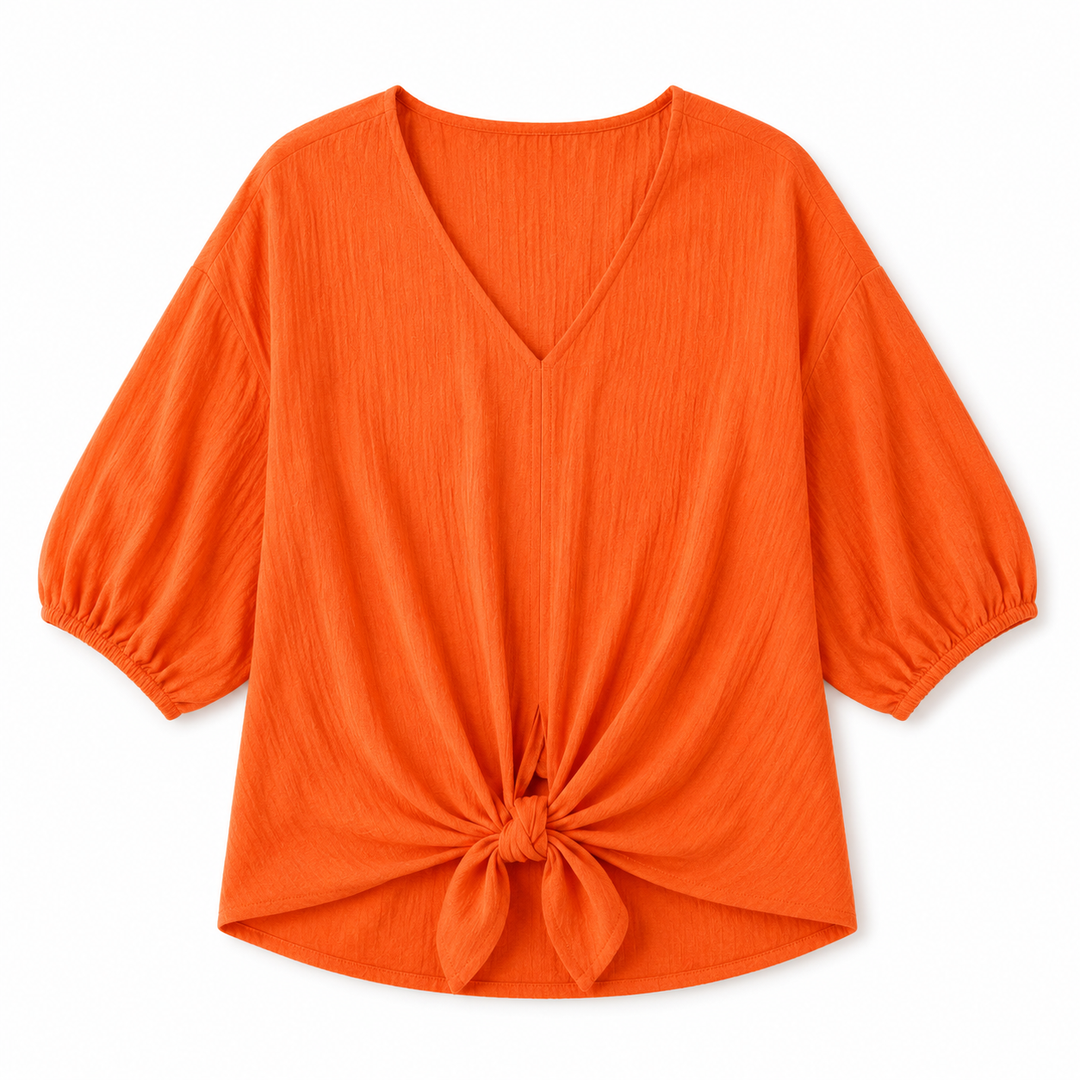 Bright orange crinkle-textured blouse with a V-neckline, balloon sleeves, and a front knot detail at the hem, shown on a plain white background.