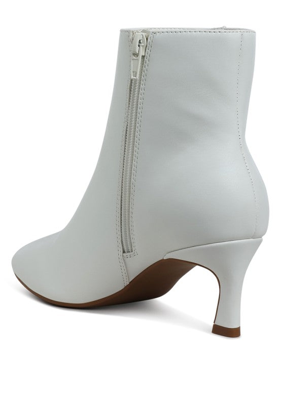 White ankle boot with a zipper on a white background
