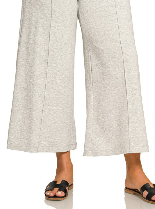 Light gray wide-leg pants worn by a person on a white background