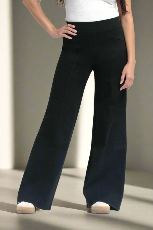 Black wide-leg pants worn by a person on a white background
