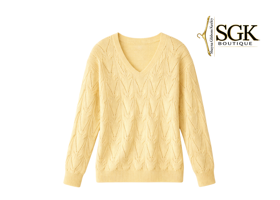 Yellow cable knit sweater on a white background with SGK Boutique logo.