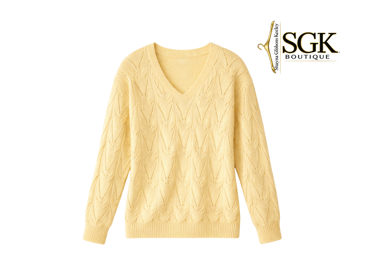 Yellow cable knit sweater on a white background with SGK Boutique logo.