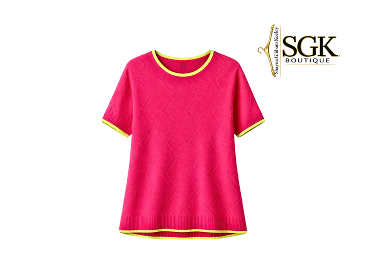 Pink sweater with yellow trim on a white background, featuring the SGK Boutique logo.